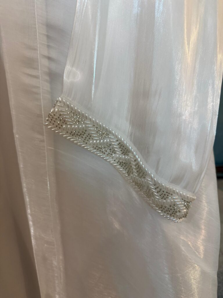 Detailed embellishments on a princess white designer abaya - Noor e Muslimah.